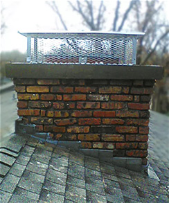 Completed installed chimney crown and cap with trees in the background