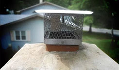 Stock photo -stainless steel chimney cap-Black Velvet Chimney Installed stainless steel chimney cap, nice brown and house in the background