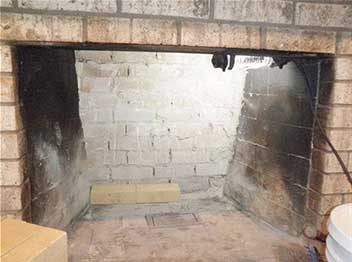 Fireplace firebox in process of masonry repairs