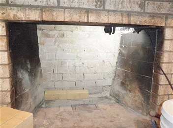 Stock photo of fireplace firebox-Black Velvet Chimney Fireplace firebox in process of masonry repairs