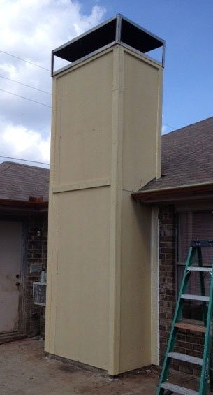 Prefab wooden chimney with ladder to the right