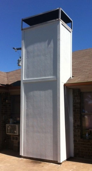Wooden chimney painted white after prefab chimney repair and installation