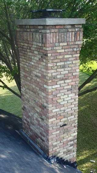 Multi-color brick chimney spalling-we do masonry including tuckpointing, brick replacement  and rebuilds