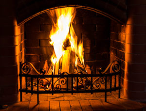 classic masonry fireplace with flames